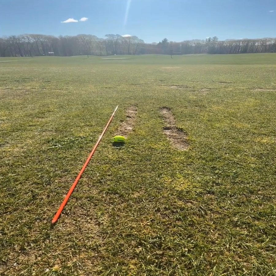 Divot line drill on the grass range at Southborough Golf Center: a straight line of divots beside an alignment stick
